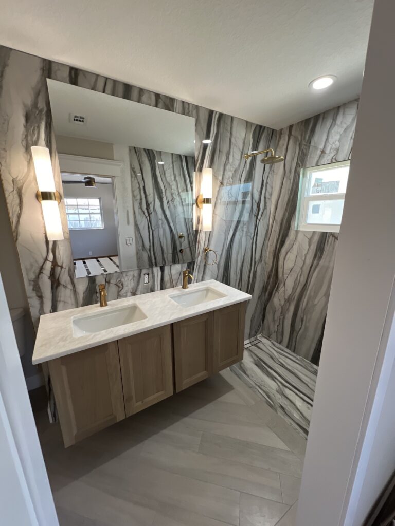 Finished dramatic marble bathroom with floating vanity by All Surface Experts Co.